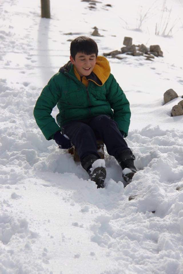 Ibrahim sledding through the snow during his years in Çamoluk