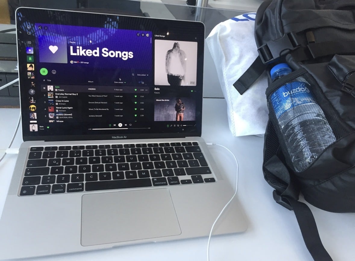 A laptop and travel bag while waiting for the flight to Poland