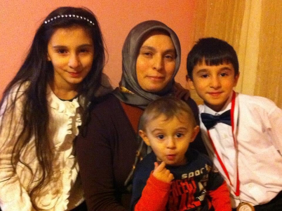 Ibrahim with his family after a primary school ceremony in Bursa